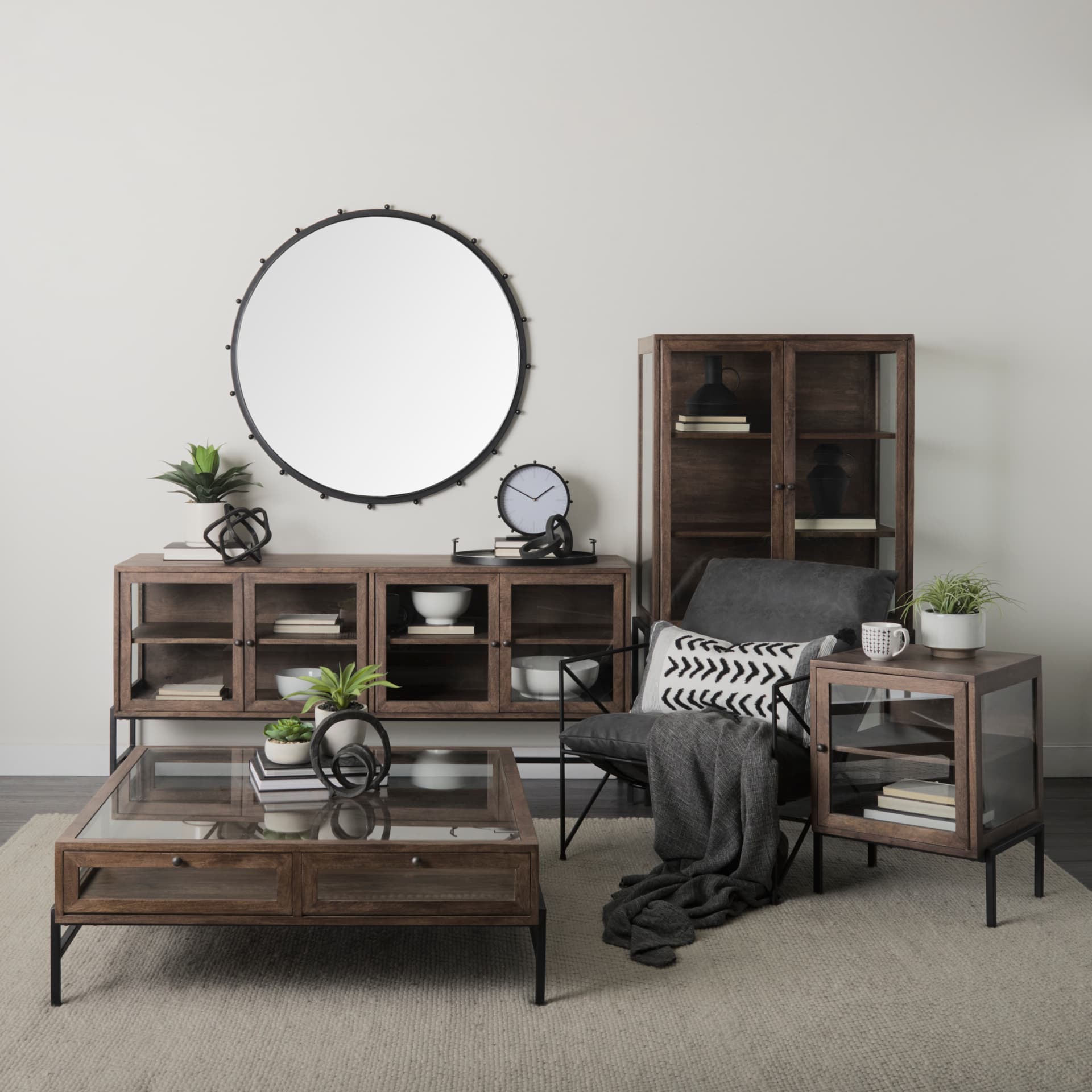 Arelius 36L x 18.75W x 63H Medium Brown Wood W/ Black Metal Base Display Cabinet — in a styled room
