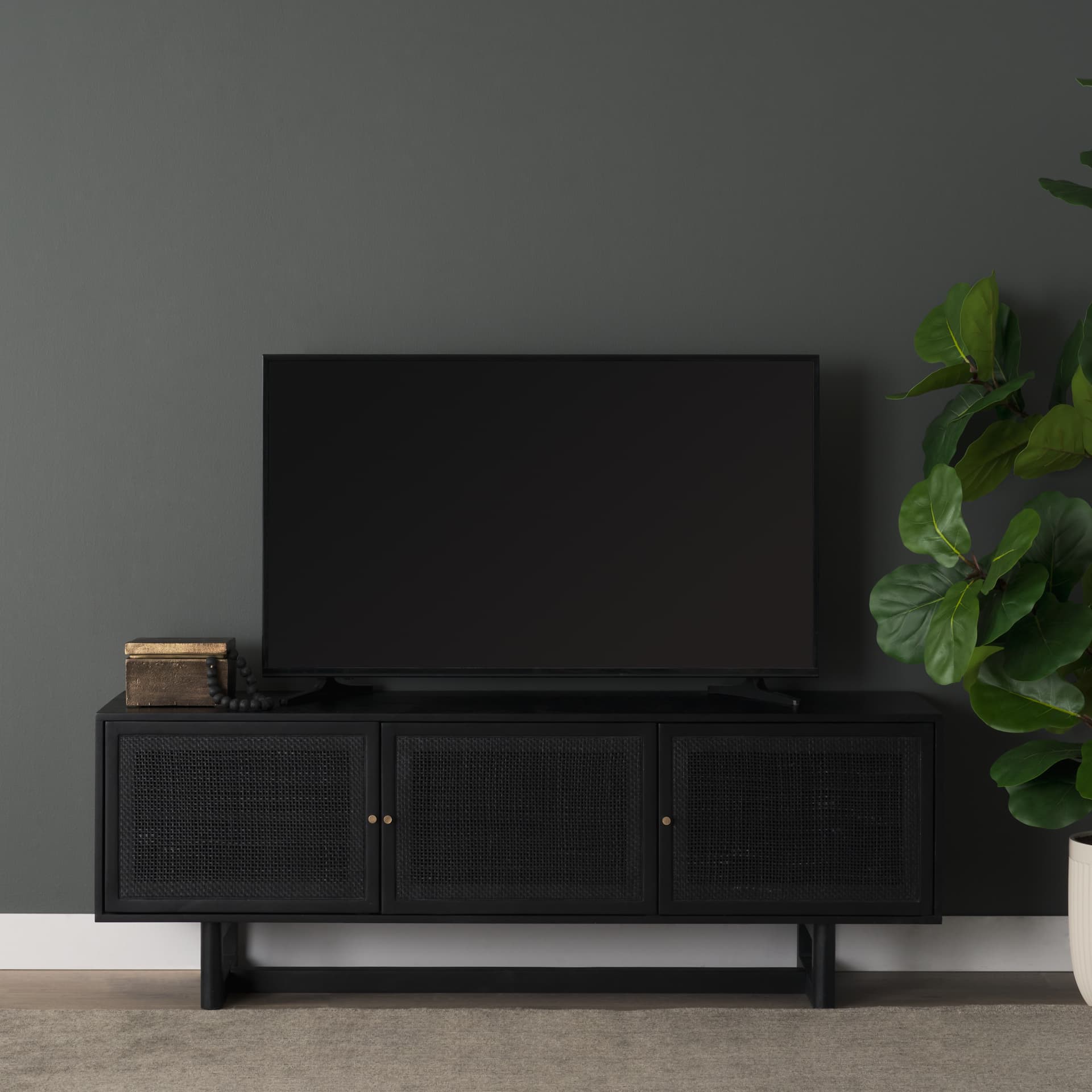 Grier 65" Black Solid Wood W/ Black Cane Media Console — in a styled room
