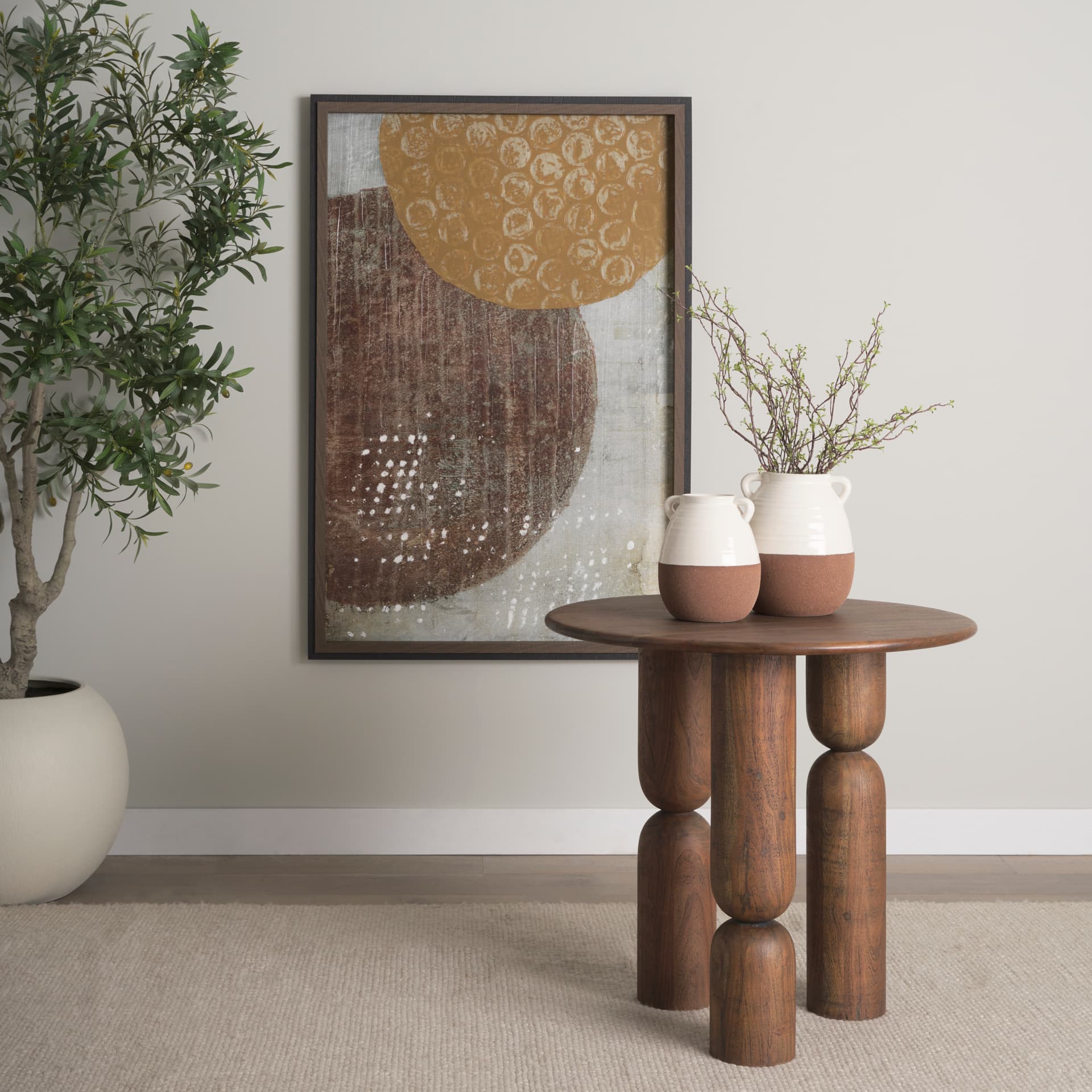 Sonel Pedestal Medium Dark Brown Acacia Wood Foyer Table — in a styled room