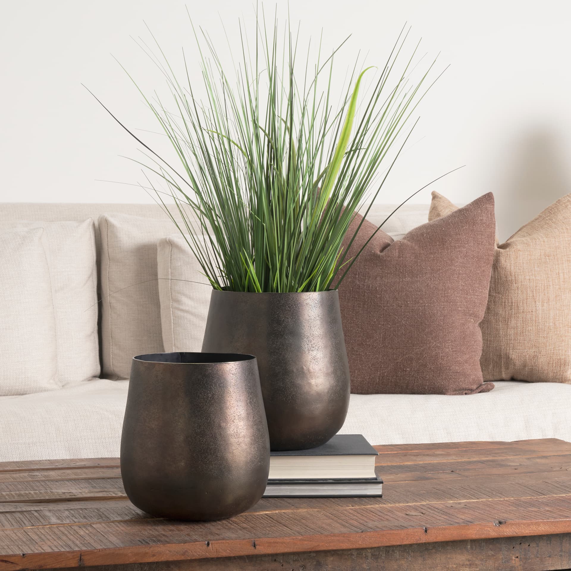 Quade Large Textured Gold Metal Planter — in a styled room