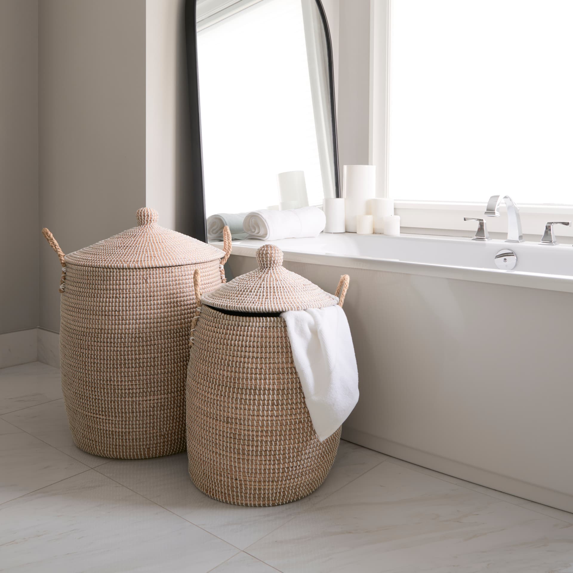 Kairi Set of 2 Seagrass Floor Baskets w/ Lids and Handles — in a styled room