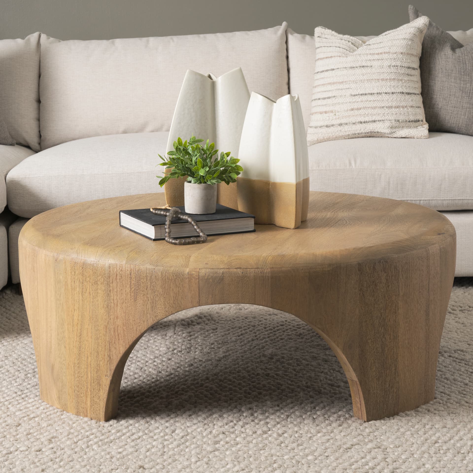 Shima Round Light Brown Wood W/Arched Legs Coffee Table — in a styled room
