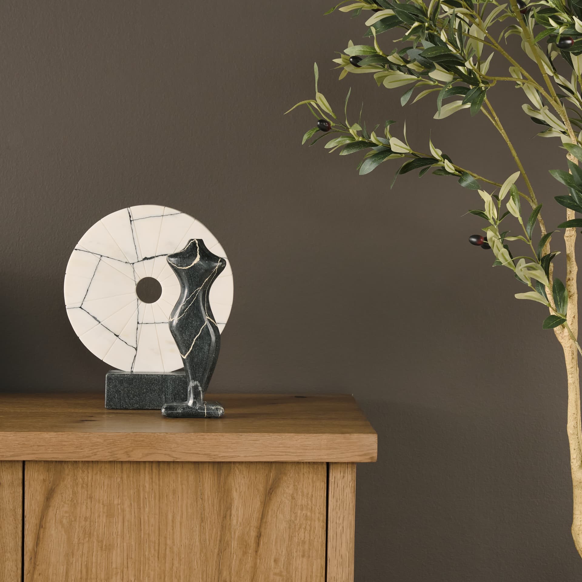Orin White Marble Round Disc Decorative Object — in a styled room