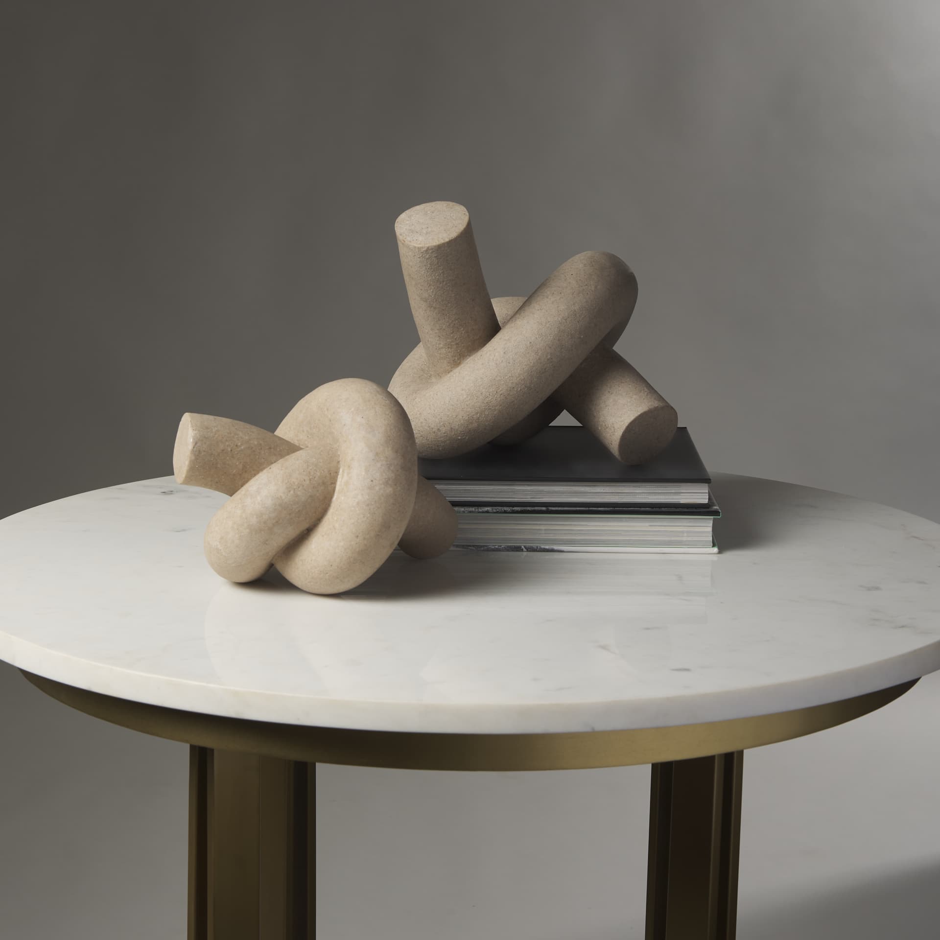 Otto Sandstone Resin Large Knot Sculpture Decorative Object — in a styled room