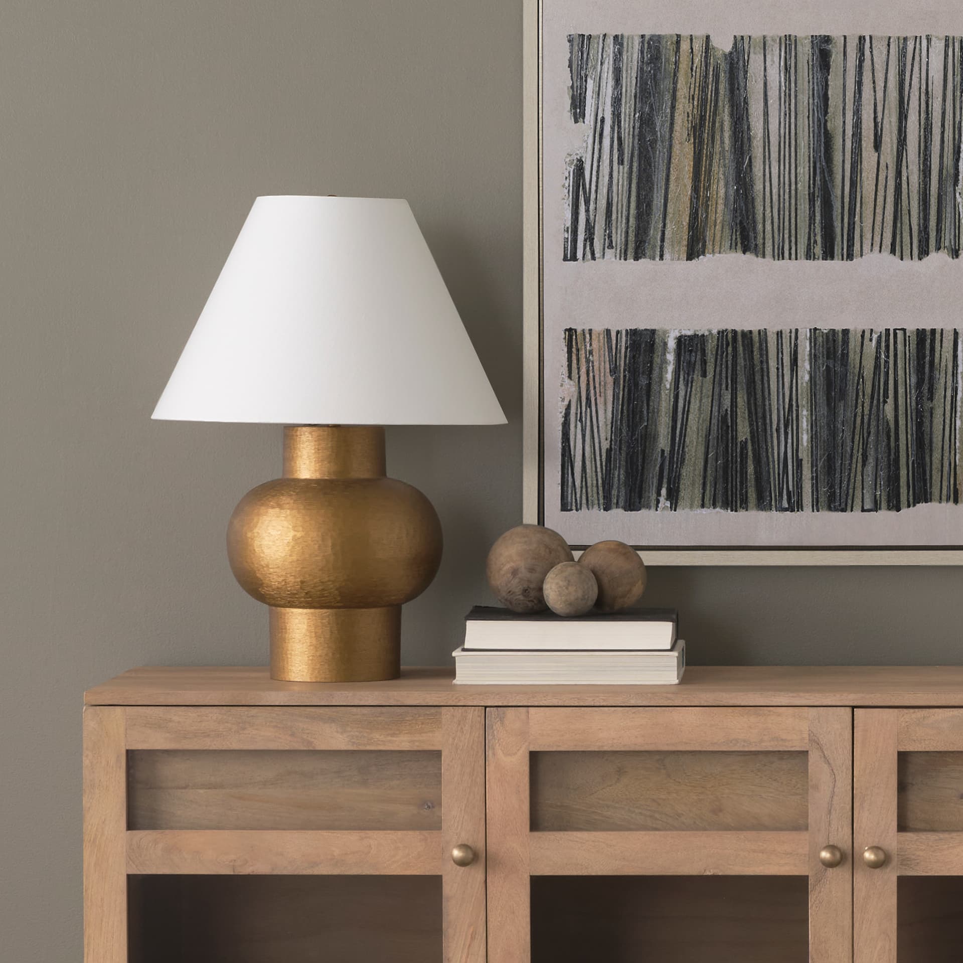 Salaah Antique Gold Brushed Metal w/ Cream Shade Table Lamp — in a styled room