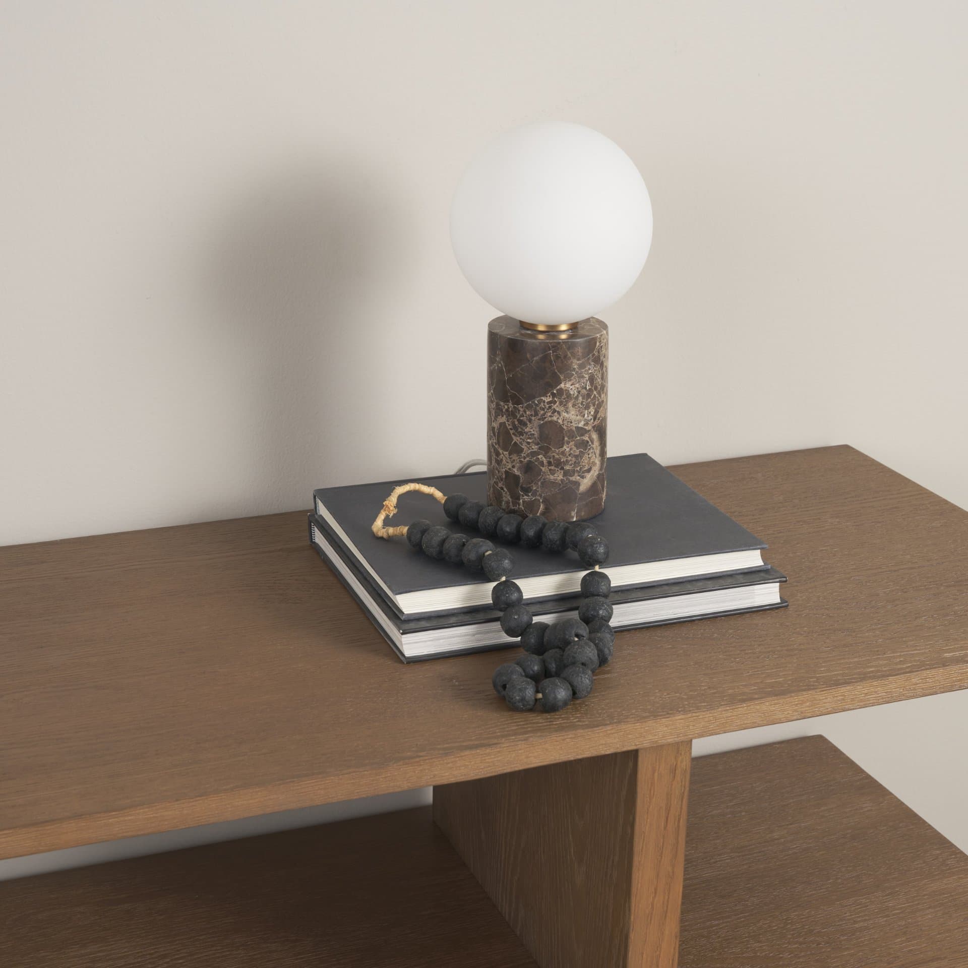 Caldo Brown Marble Base w/ Frosted Glass Globe Table Lamp — in a styled room