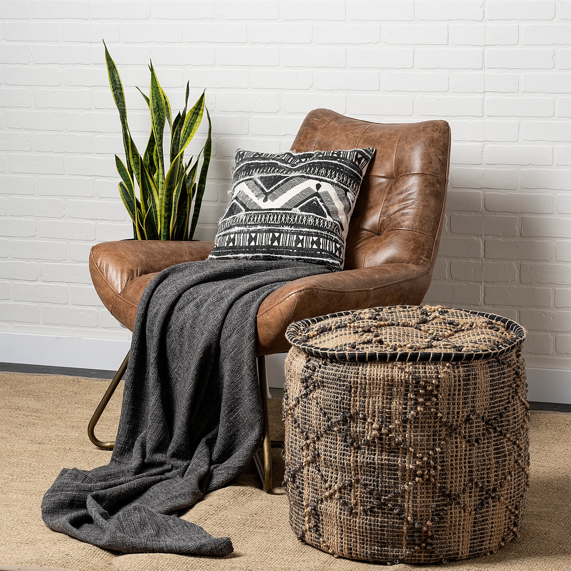 Riley Tan Jute Popcorn Stich Cylindrical Pouf — in a styled room