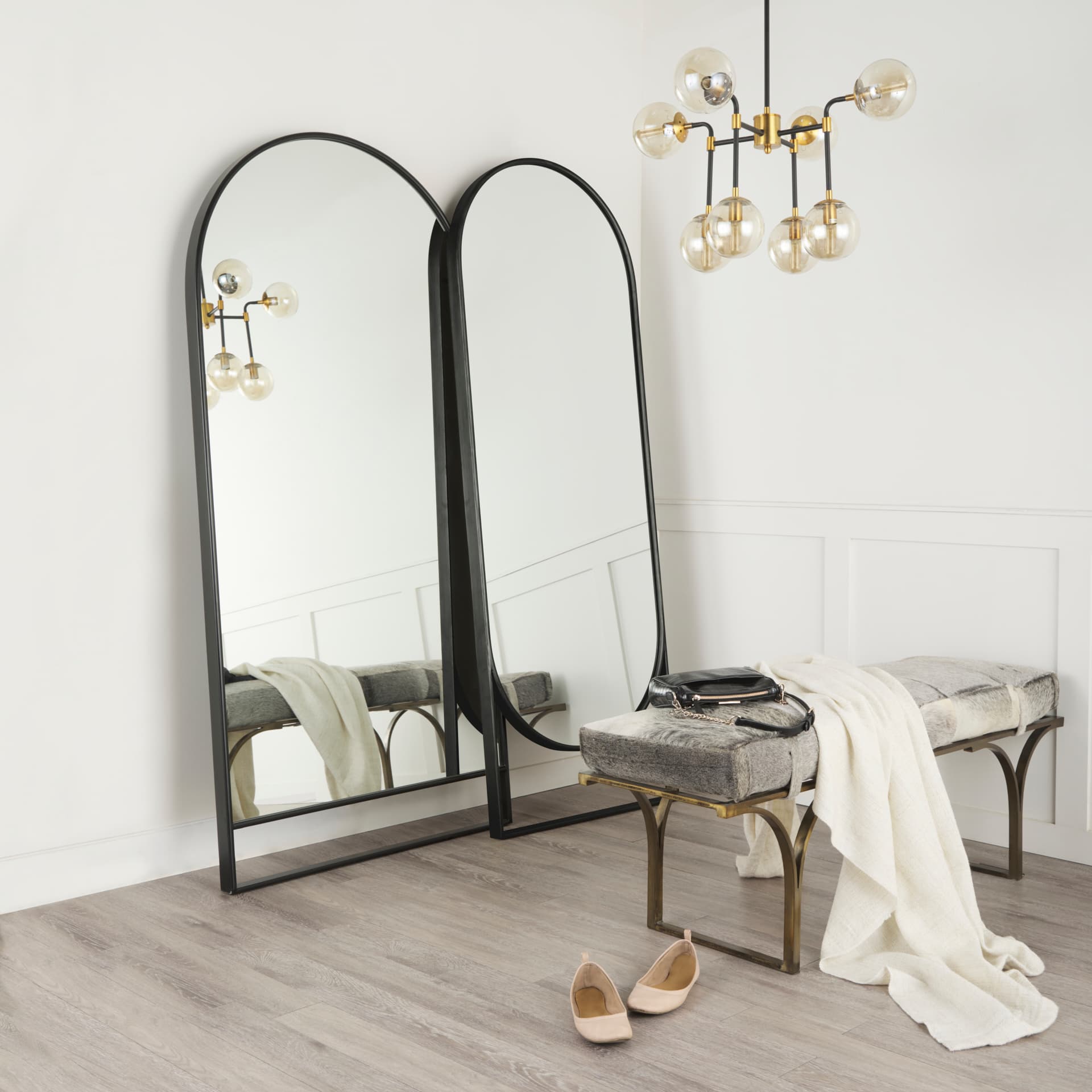 Sadie 28.0L x 2.0W x 78.0H Black Metal Rounded Arch Floor Mirror — in a styled room