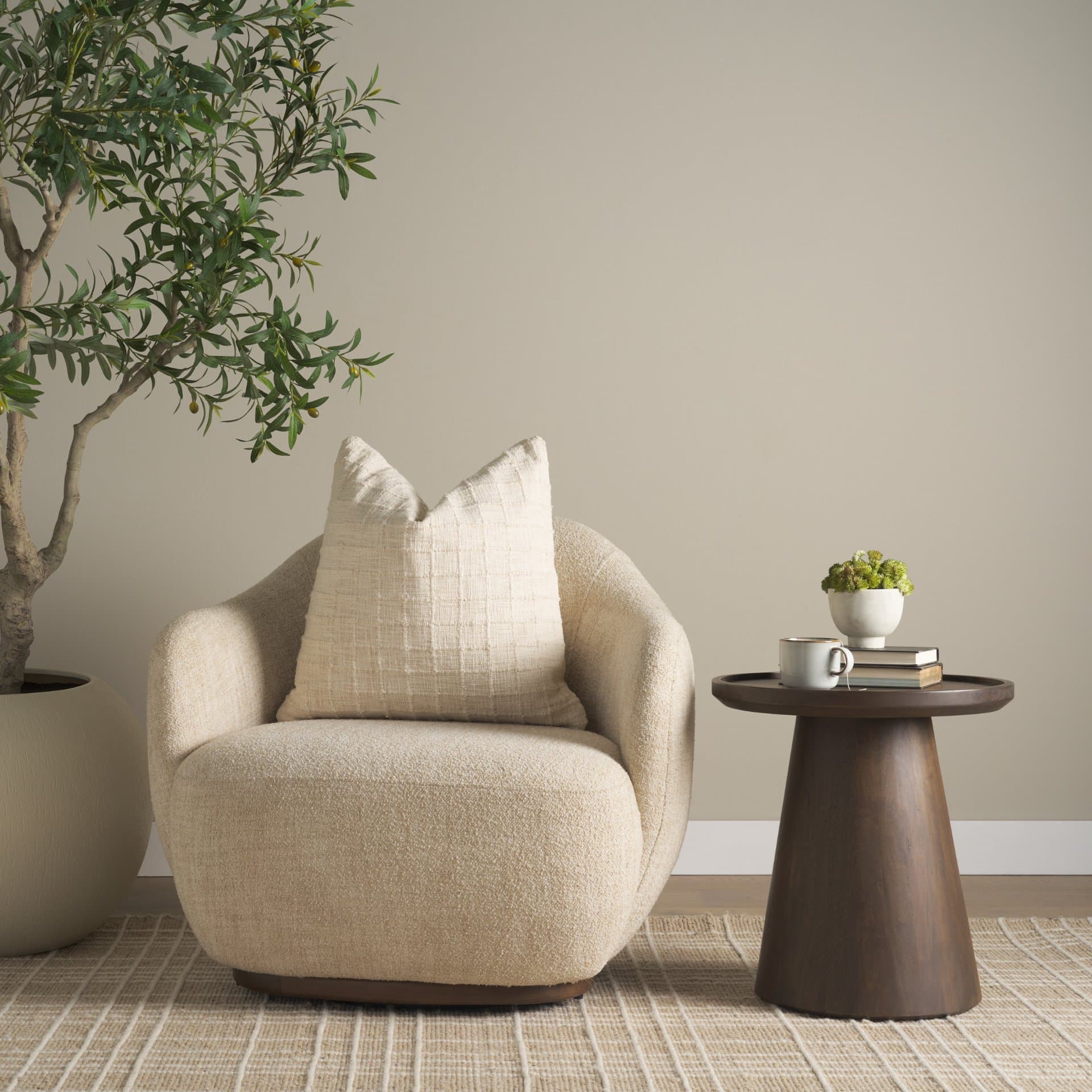 Hudson Oatmeal Fabric Upholstered Swivel Chair — in a styled room