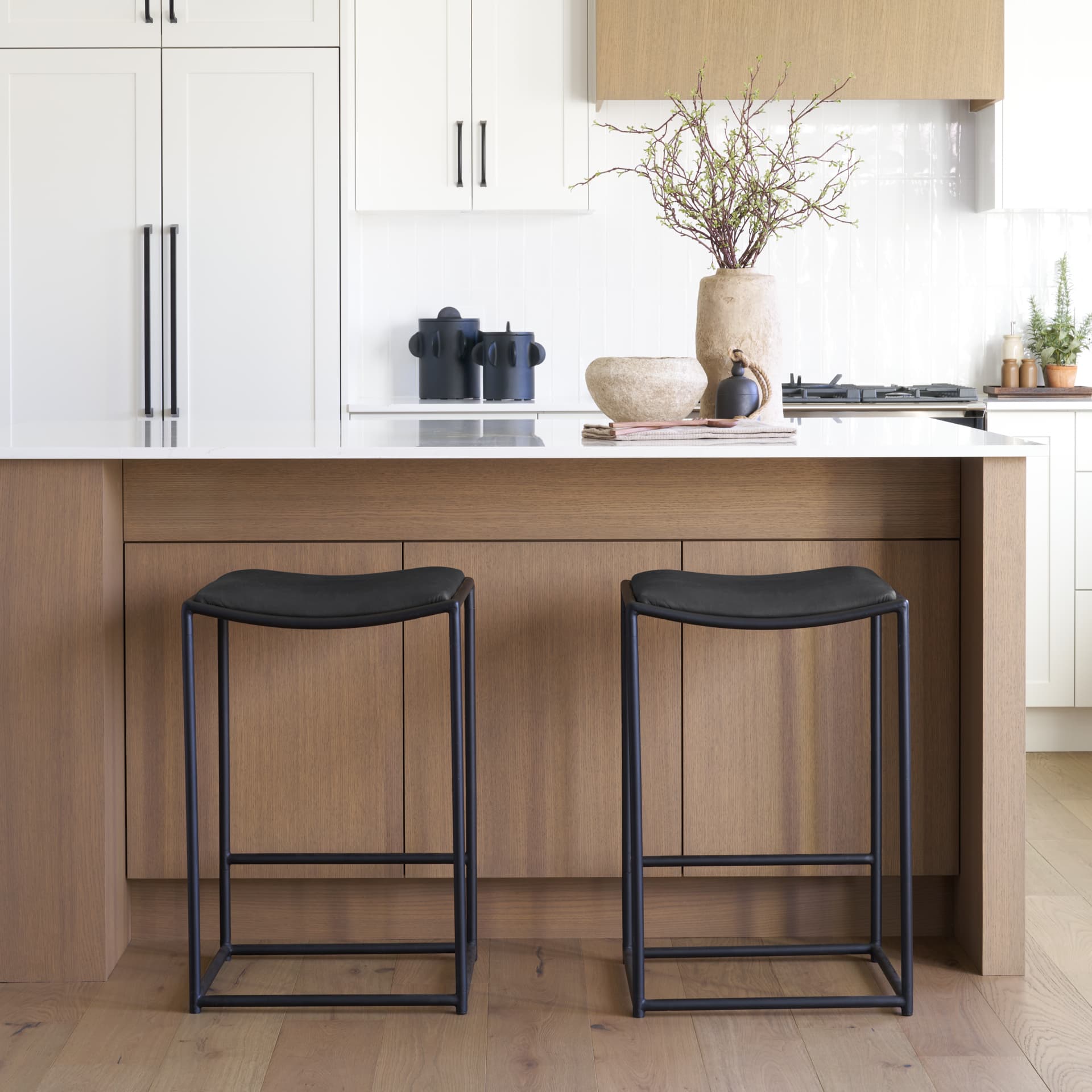 Taniel Backless 27.25in Seat Counter Stool | Black Leather w/ Metal — in a styled room