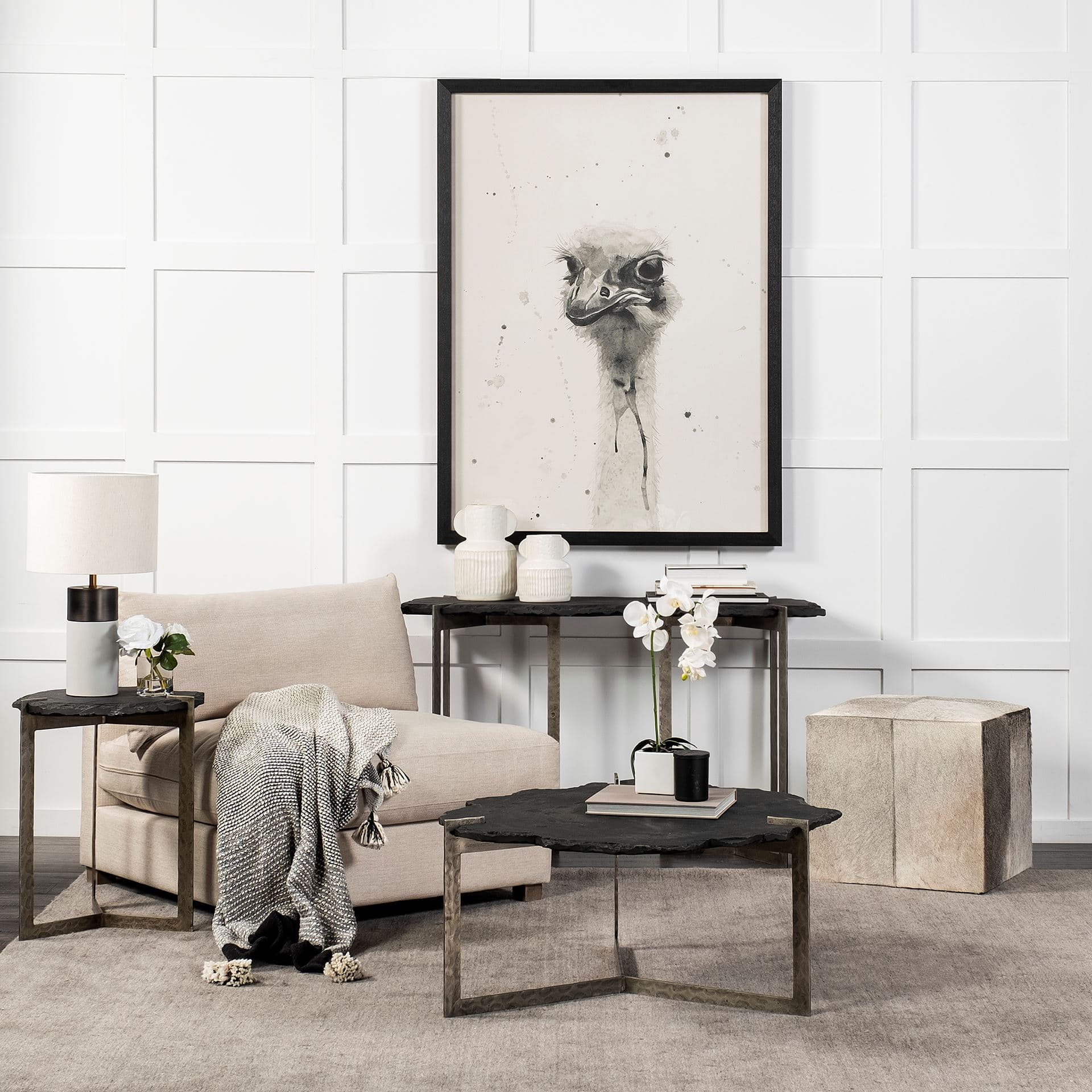 Zahavi I 20" Grey-toned hair-on-hide ottoman — in a styled room