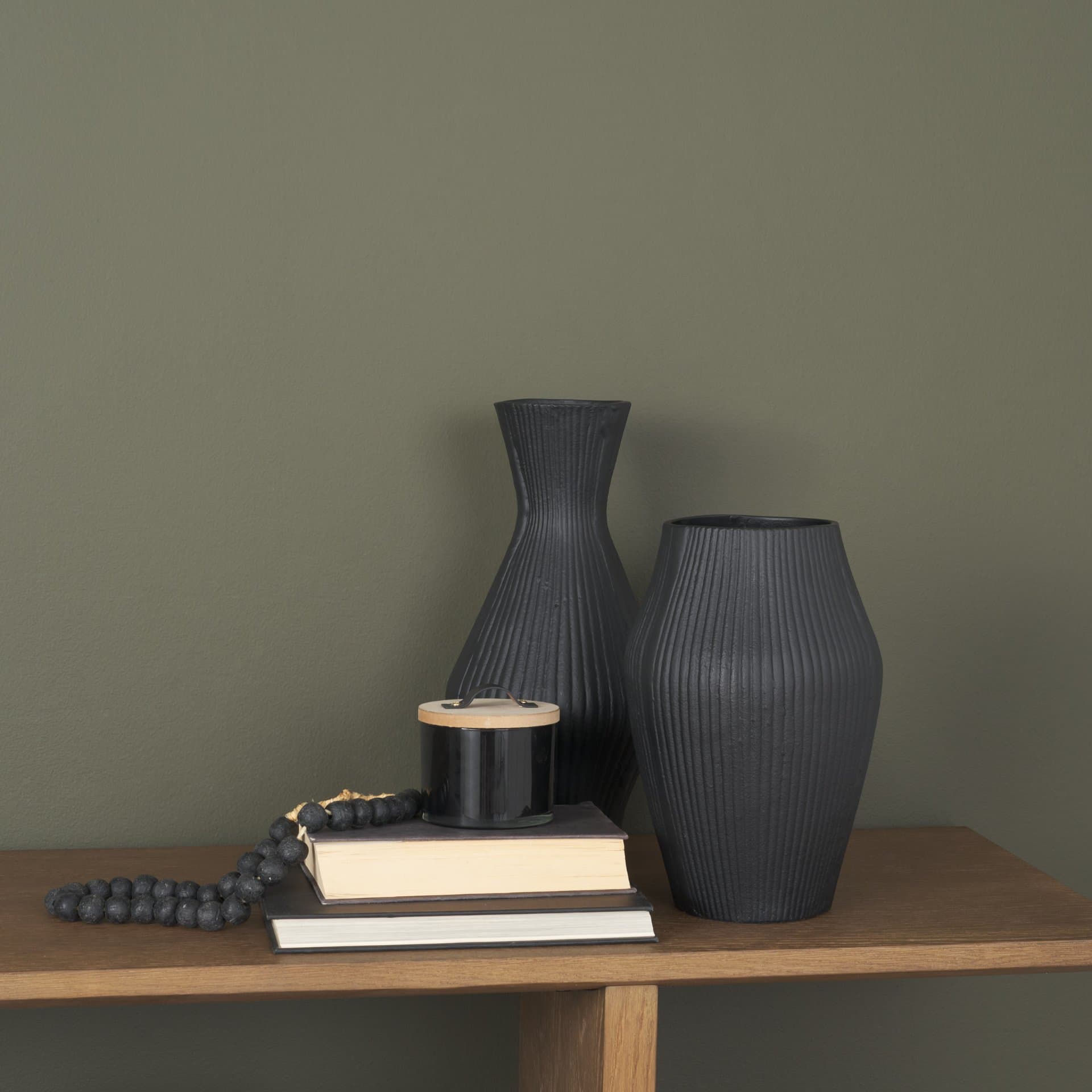 Patine Wide Matte Black Metal Fluted Decorative Vase — in a styled room