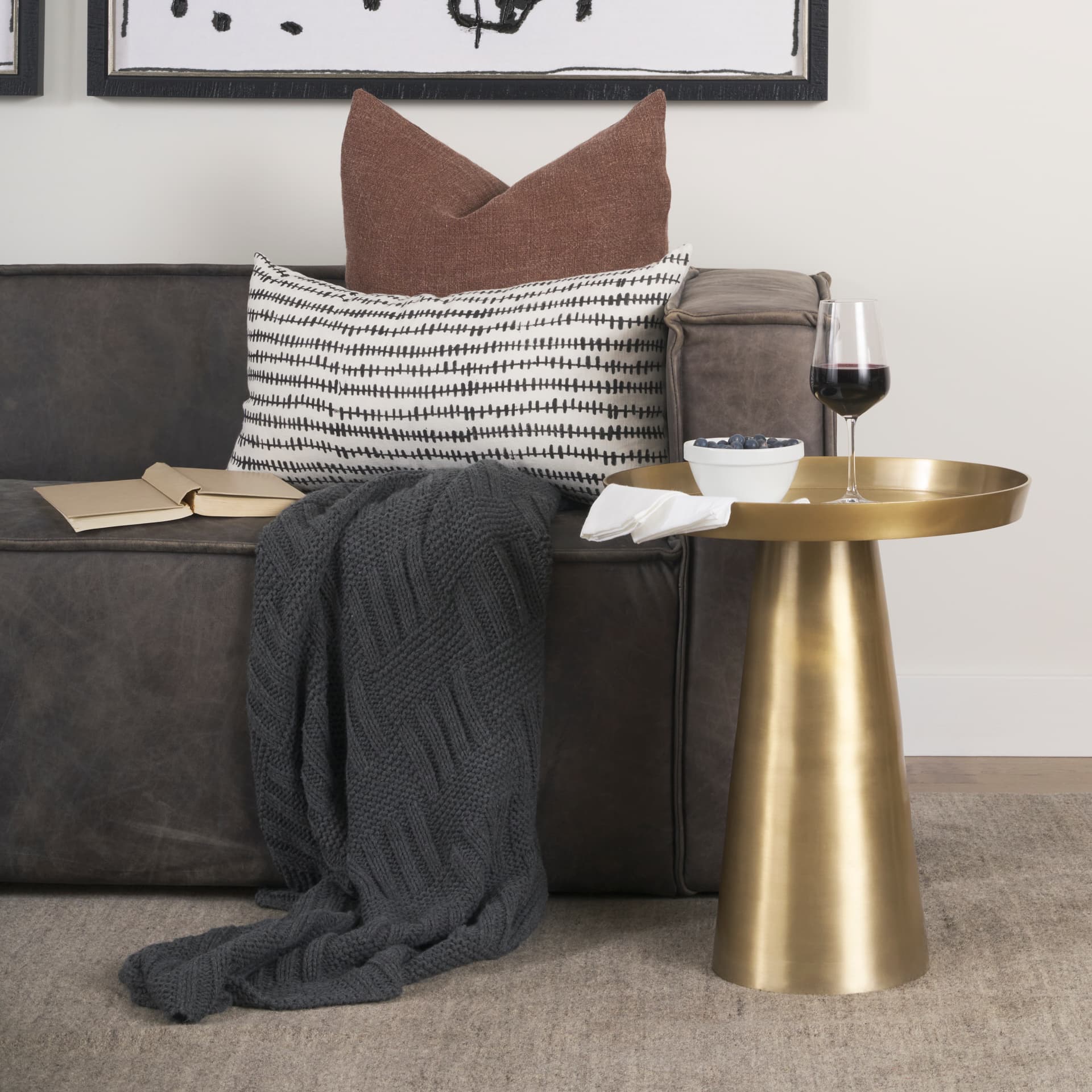 Roland Satin Brass Cast Aluminum Metal Accent Table — in a styled room