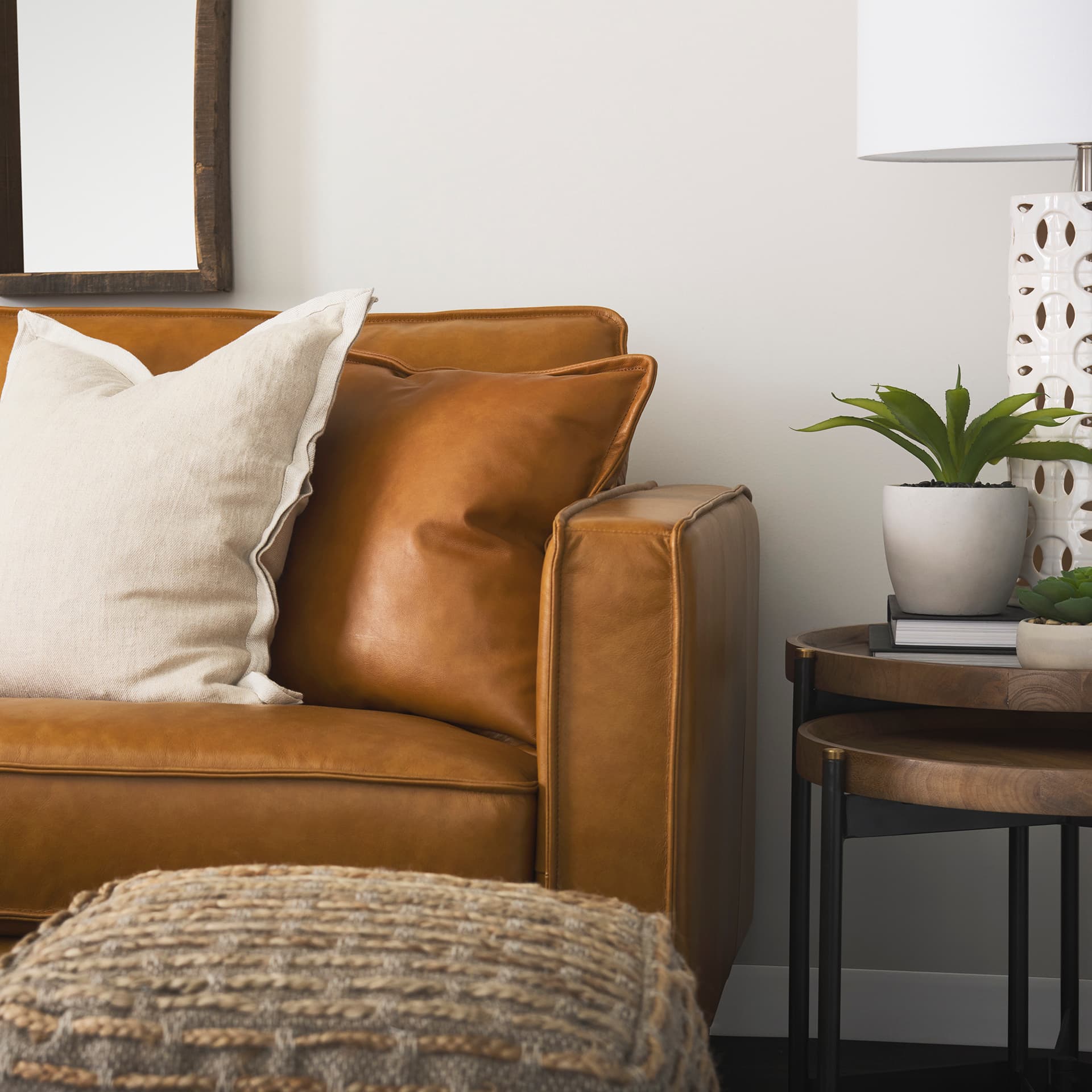 D'Arcy 65.0L x 37.0W x 34.0H Tan Leather Love Seat — in a styled room