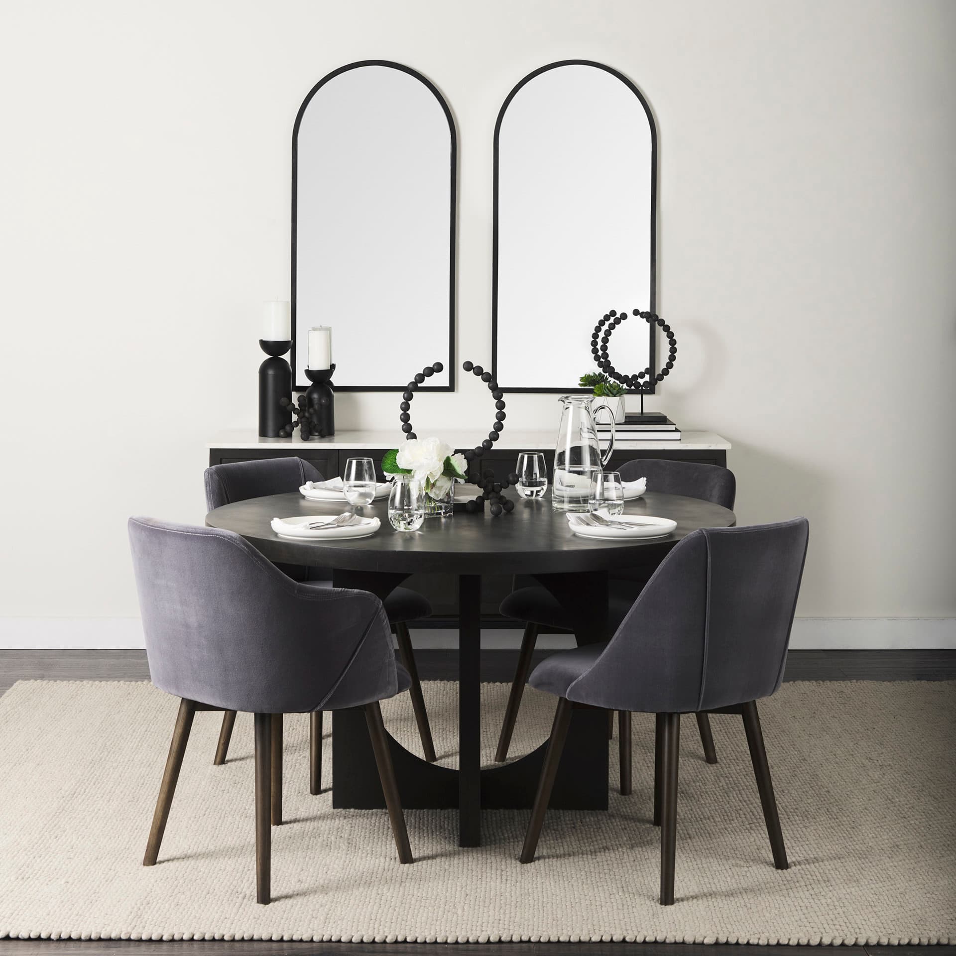 Giovanna 23.6L x 1.2W x 48.8H Black Metal Frame Rounded Arch Vanity Mirror — in a styled room