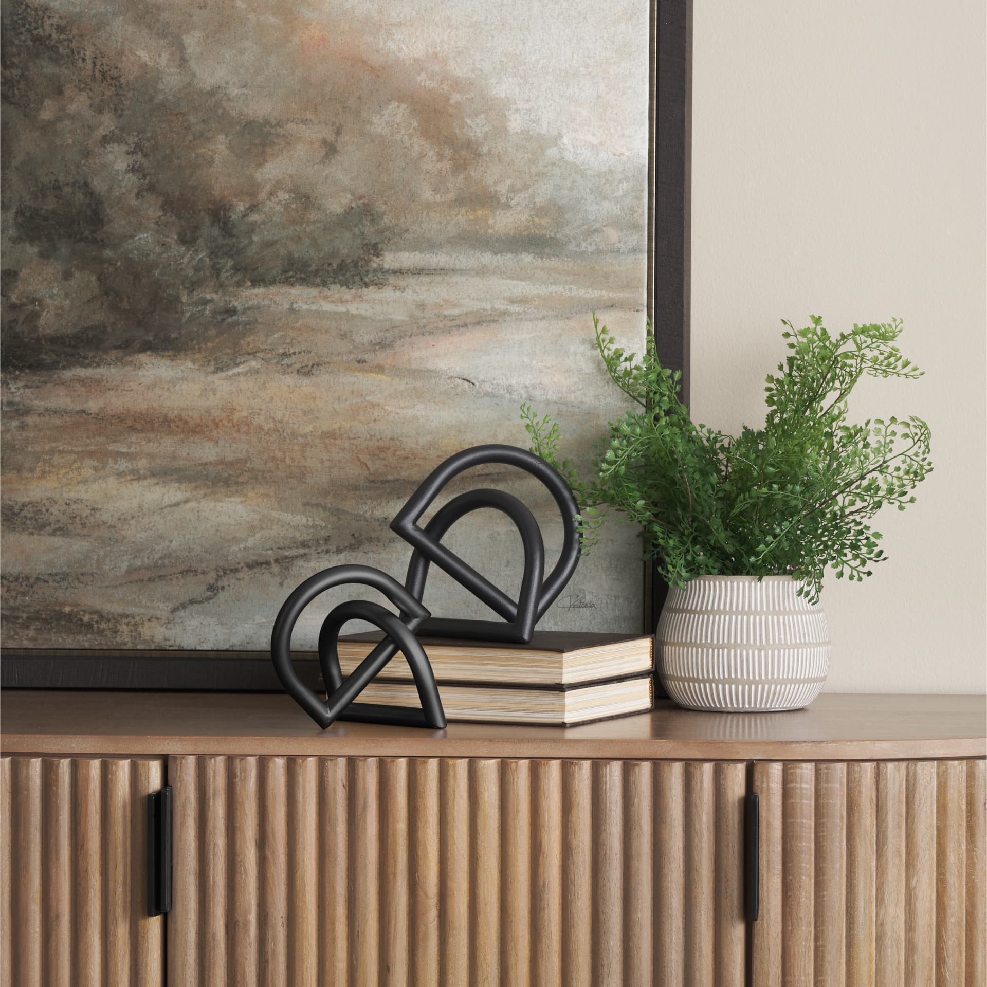 Locke Large Matte Black Metal Decorative Object — in a styled room