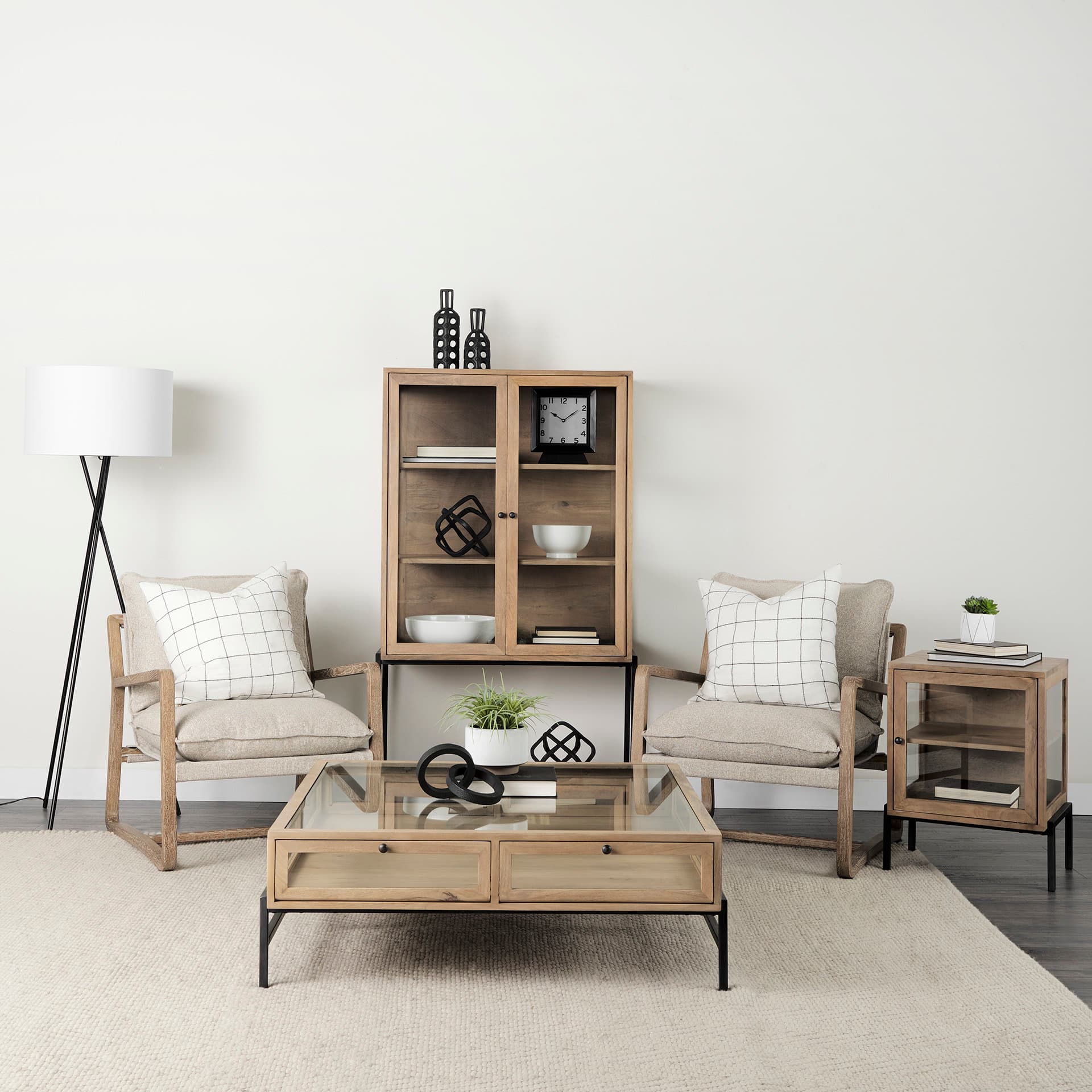 Arelius 36L x 18.75W x 63H Light Brown Wood W/ Black Metal Base Display Cabinet — in a styled room