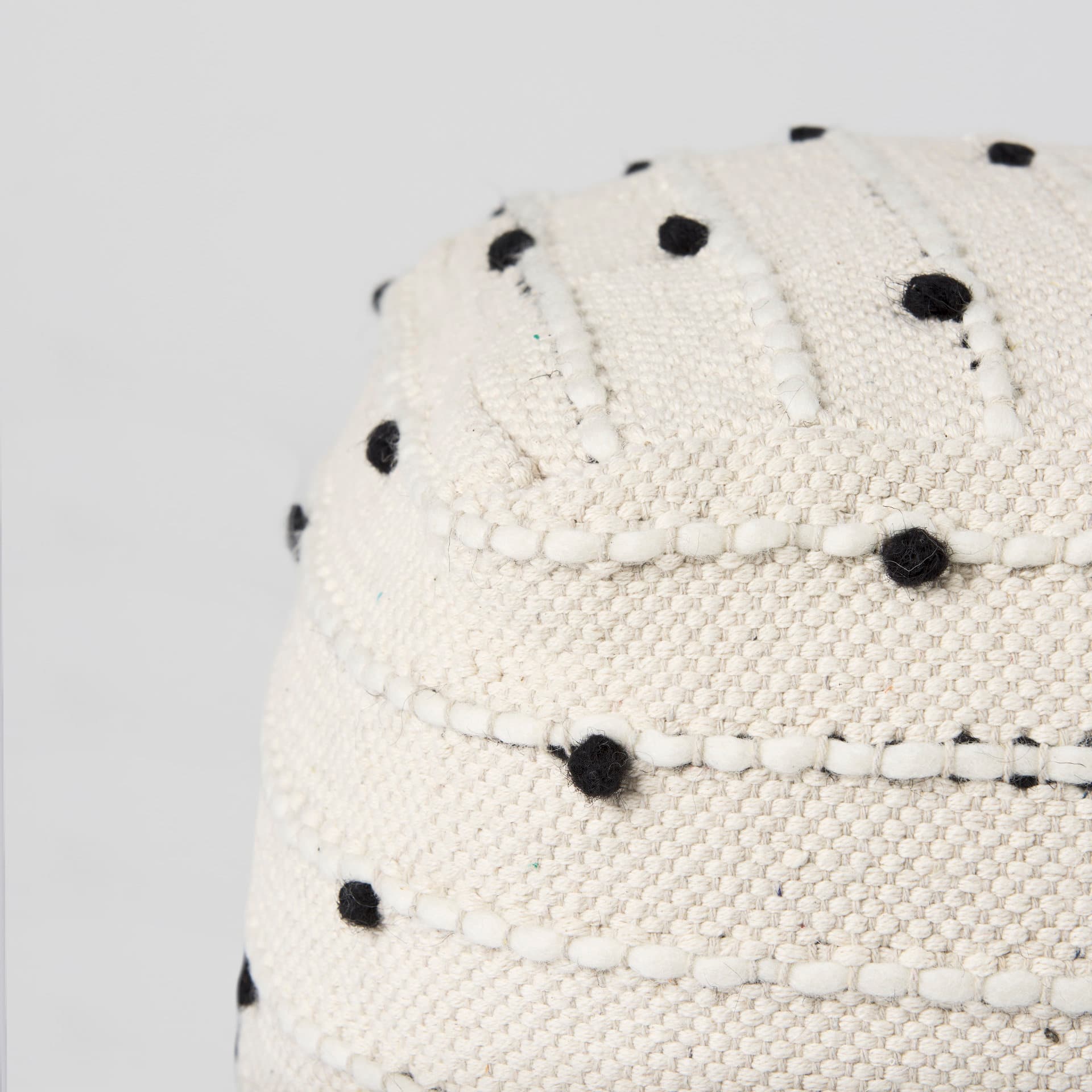 Amaira 16.0L x 16.0W x 16.0H Cream/Black/White patterned Wool and Cotton Pouf — product photograph