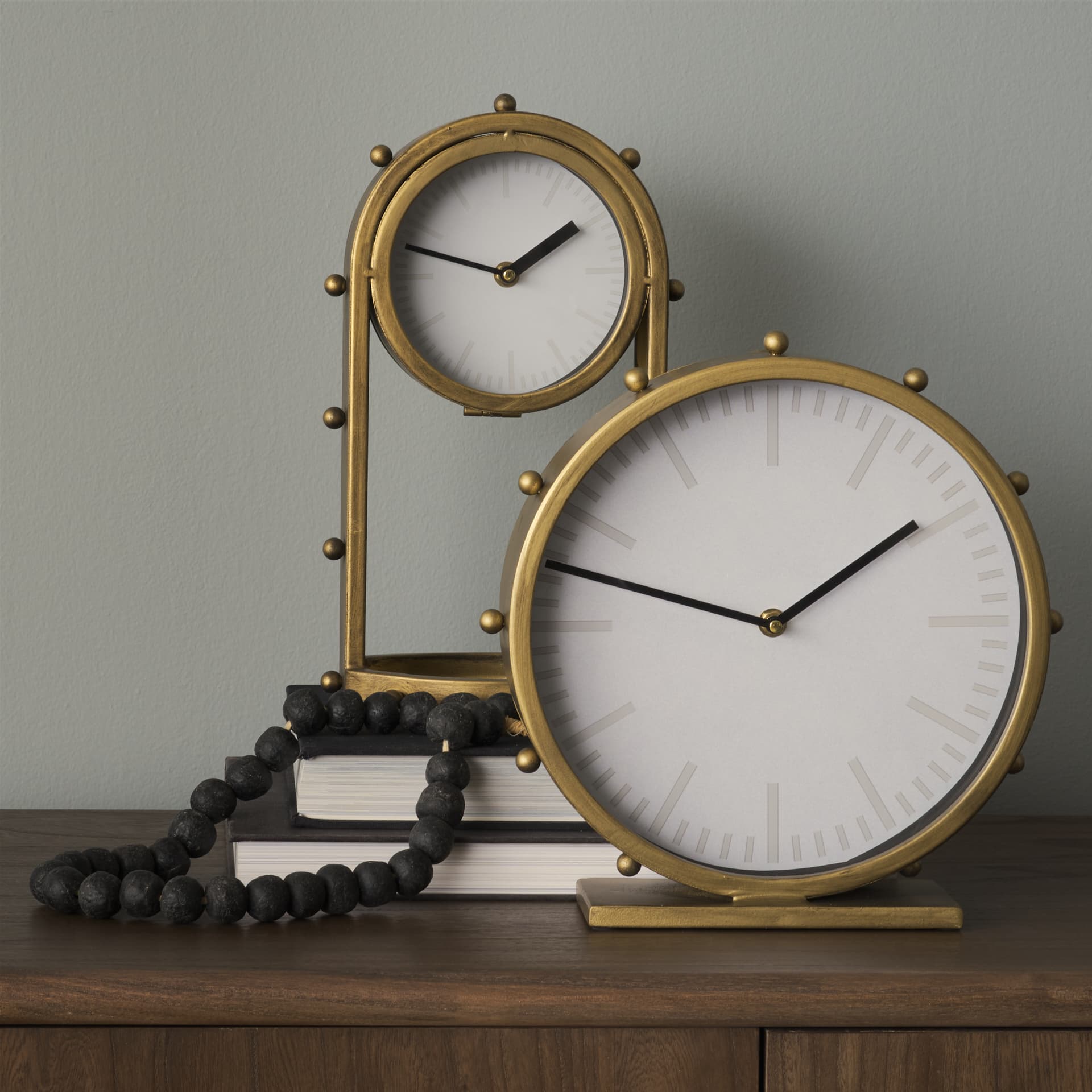 Marian 11.0L x 3.1W x 11.0H Gold Metal W/Studs Round Table Clock — in a styled room