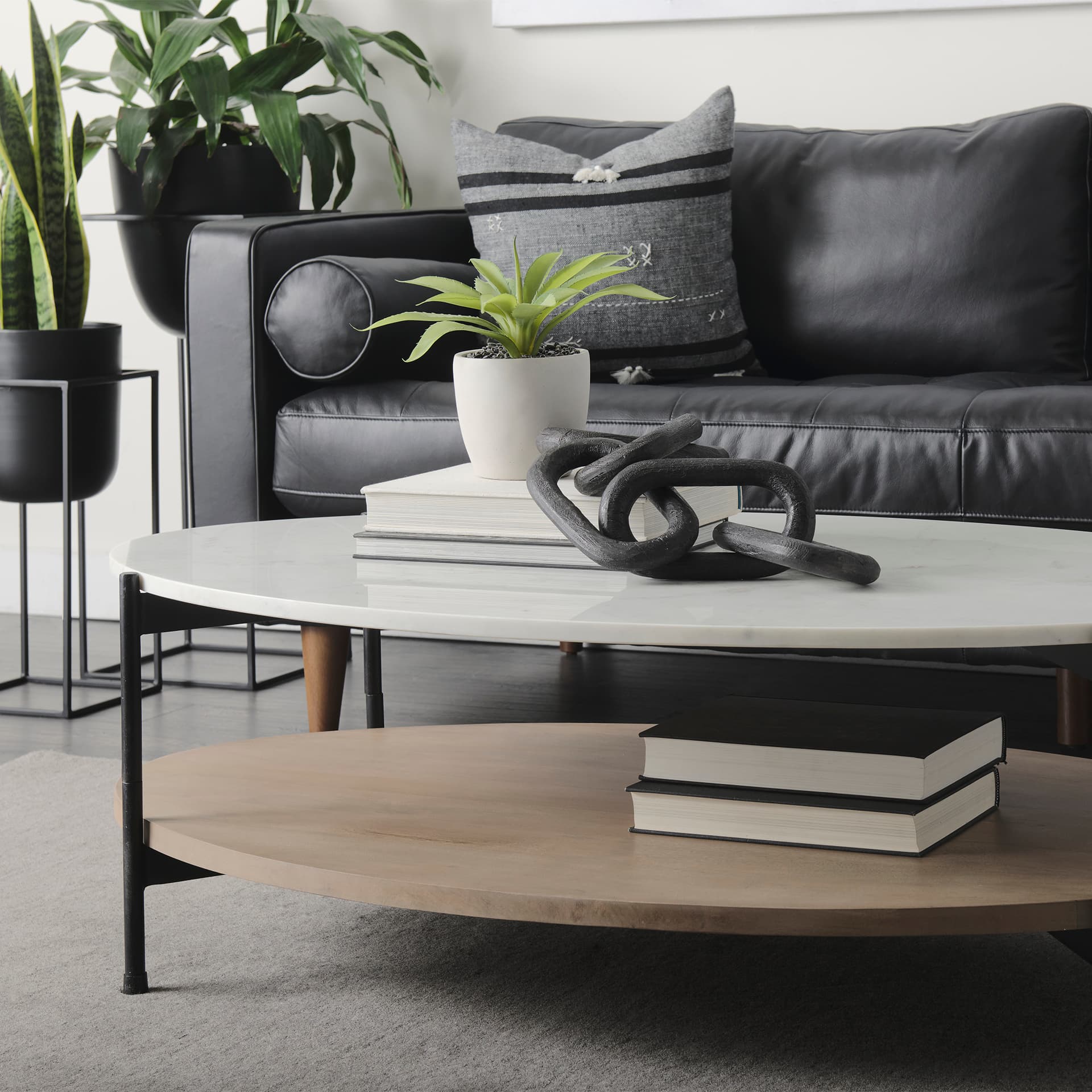 Larkin 48" Oval White Marble Top and Solid Wood Shelf w/ Black Metal Frame Coffee Table — product photograph