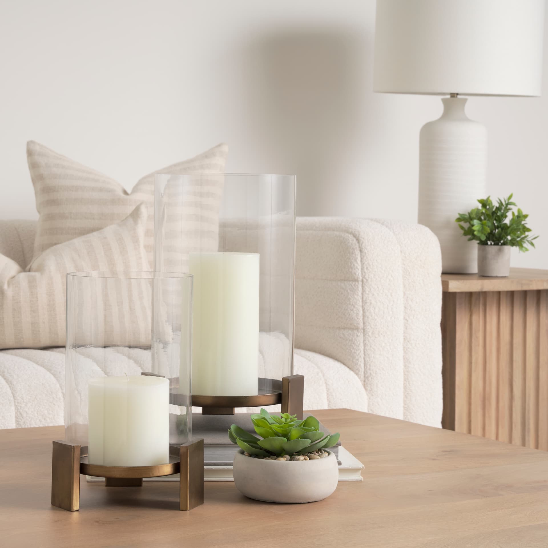Price Small Antiqued Gold Metal w/ Glass Hurricane Candle Holder — in a styled room
