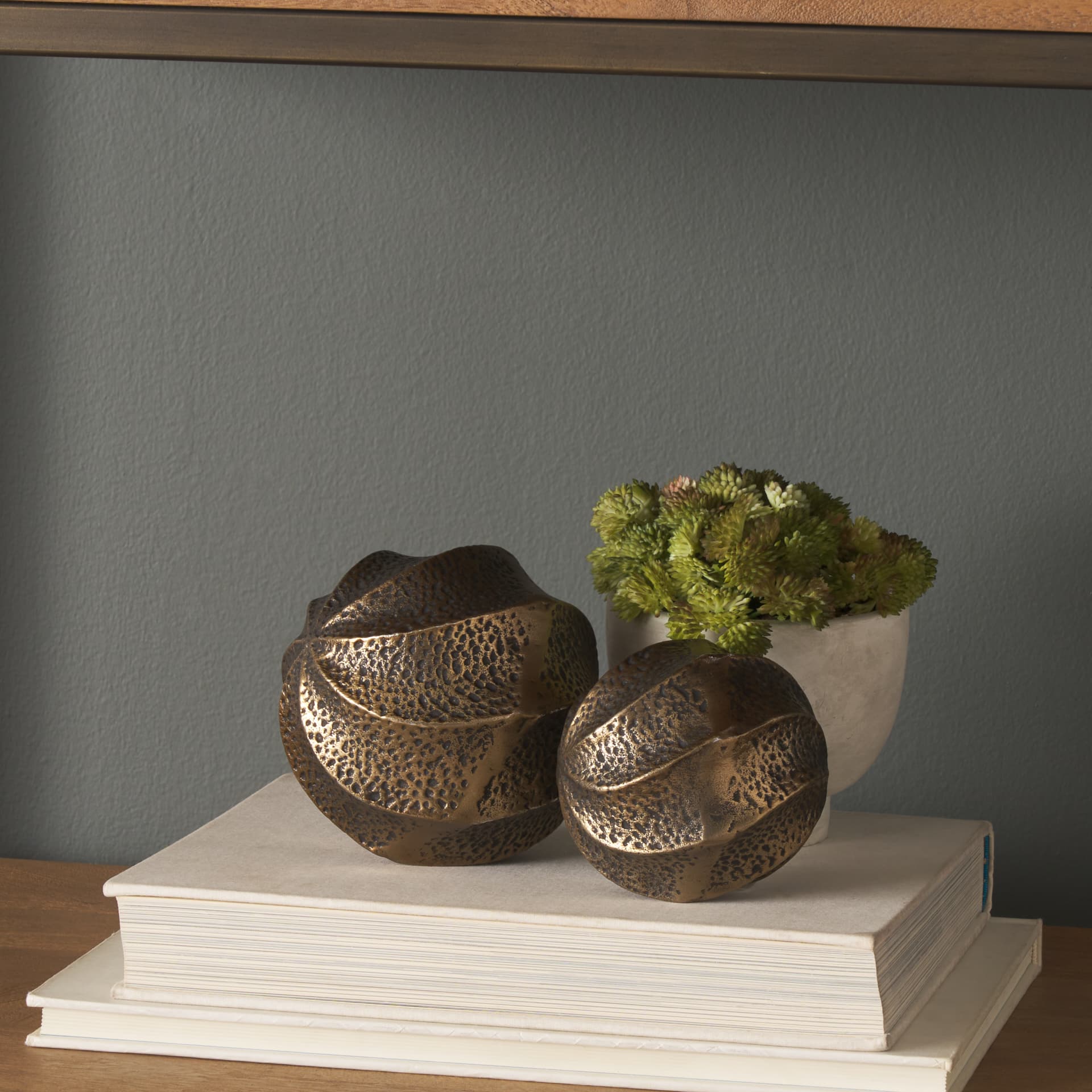 Imani Large Sculptural Textured Antiqued Gold Metal Decorative Orb Object — in a styled room