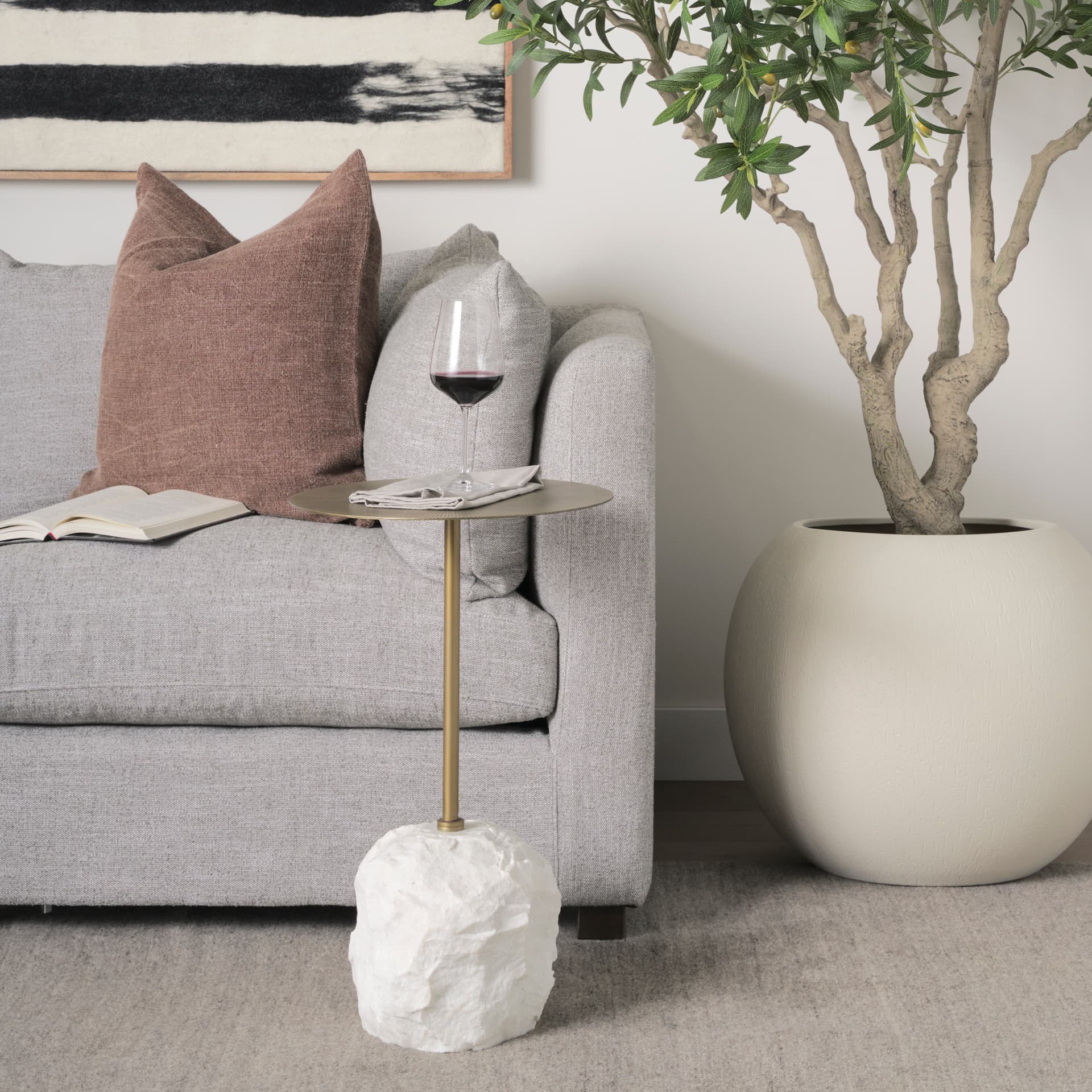 Rini Gold Metal and White Marble Accent Table — in a styled room