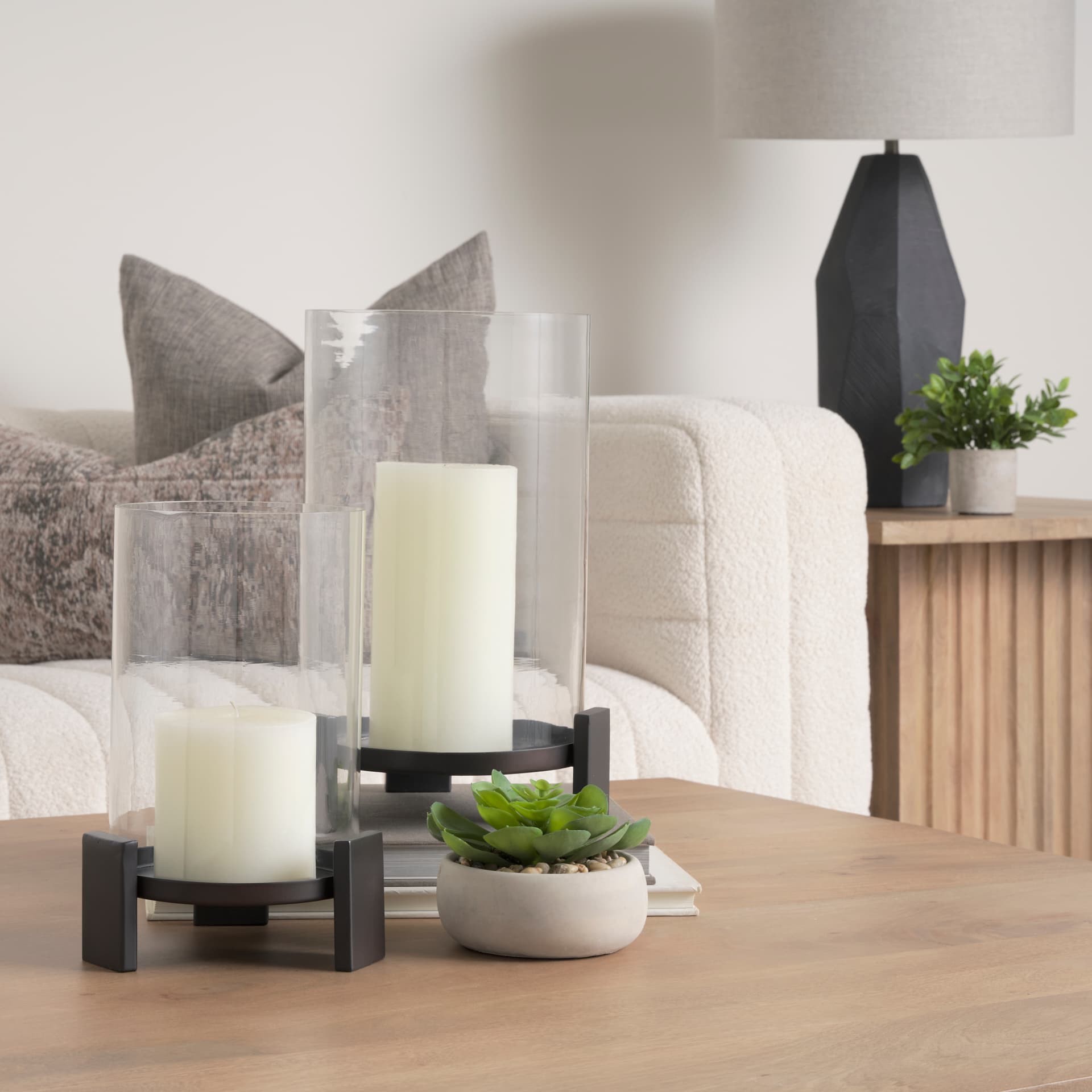 Price Large Matte Black-Brown Metal w/ Glass Hurricane Candle Holder — in a styled room