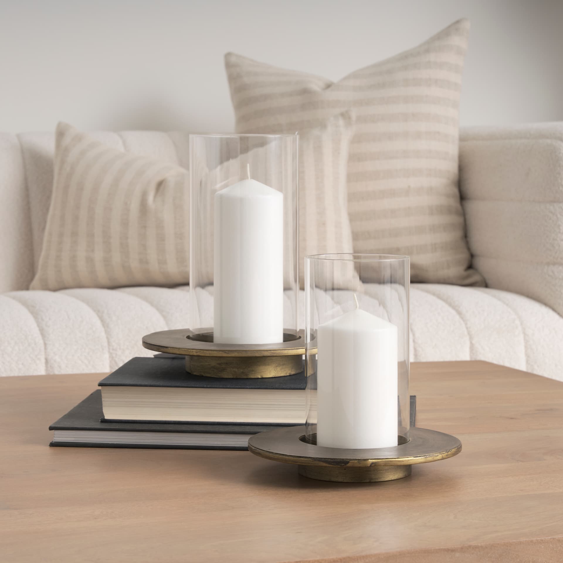 Vivian Gold Metal and Glass Hurricane Candle Holder (Set of 2) — in a styled room