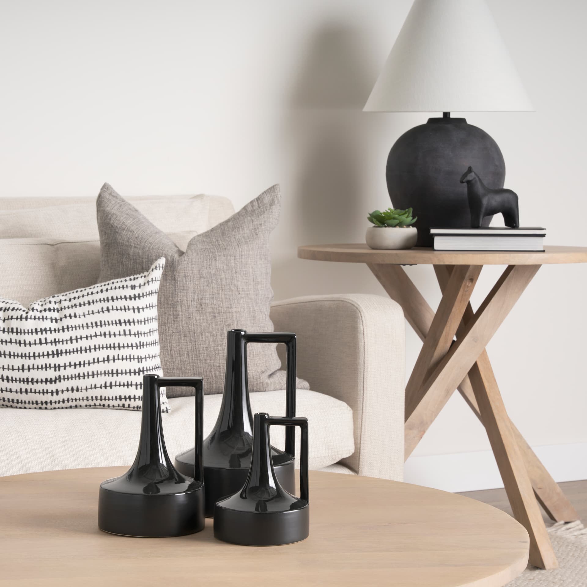 Burton 11.6H Medium Glossy and Matte Black Ceramic Jug Vase — in a styled room