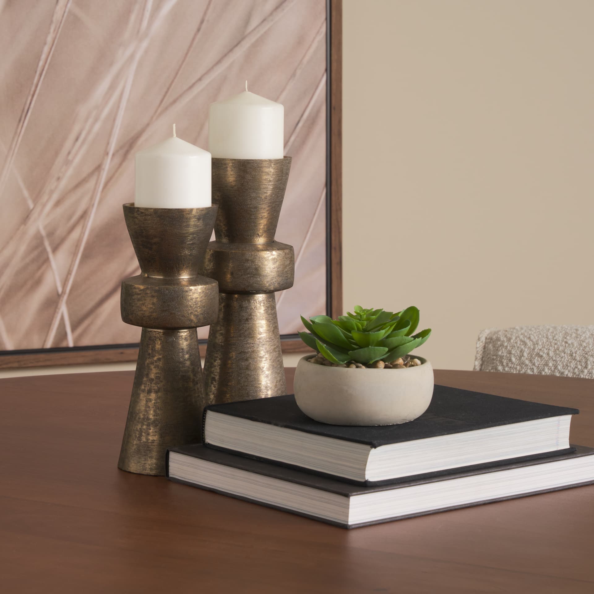 Odilia Small Textured Antiqued Gold Metal Geometric Pillar Candle Holder — in a styled room