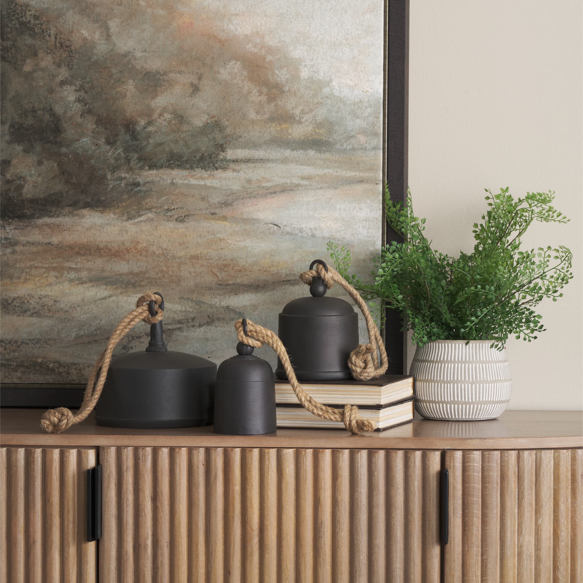 Quincy Medium Matte Black Metal Decorative Bell Object — in a styled room