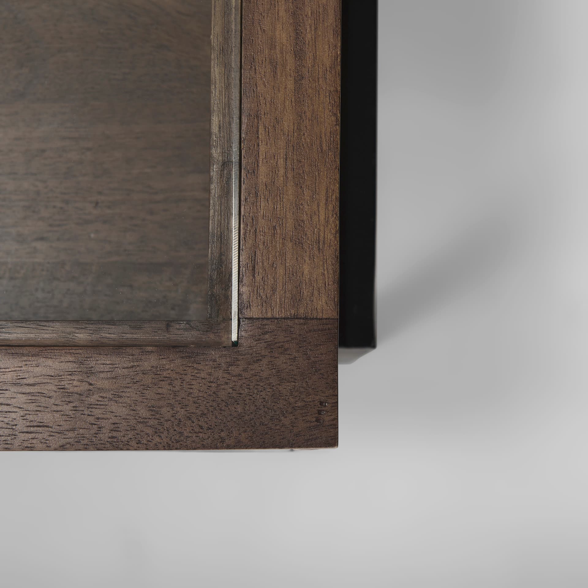 Arelius 49.5"L Rectangular Glass-Top Medium Brown Wood w/ Black Metal Base Display Coffee Table — product photograph