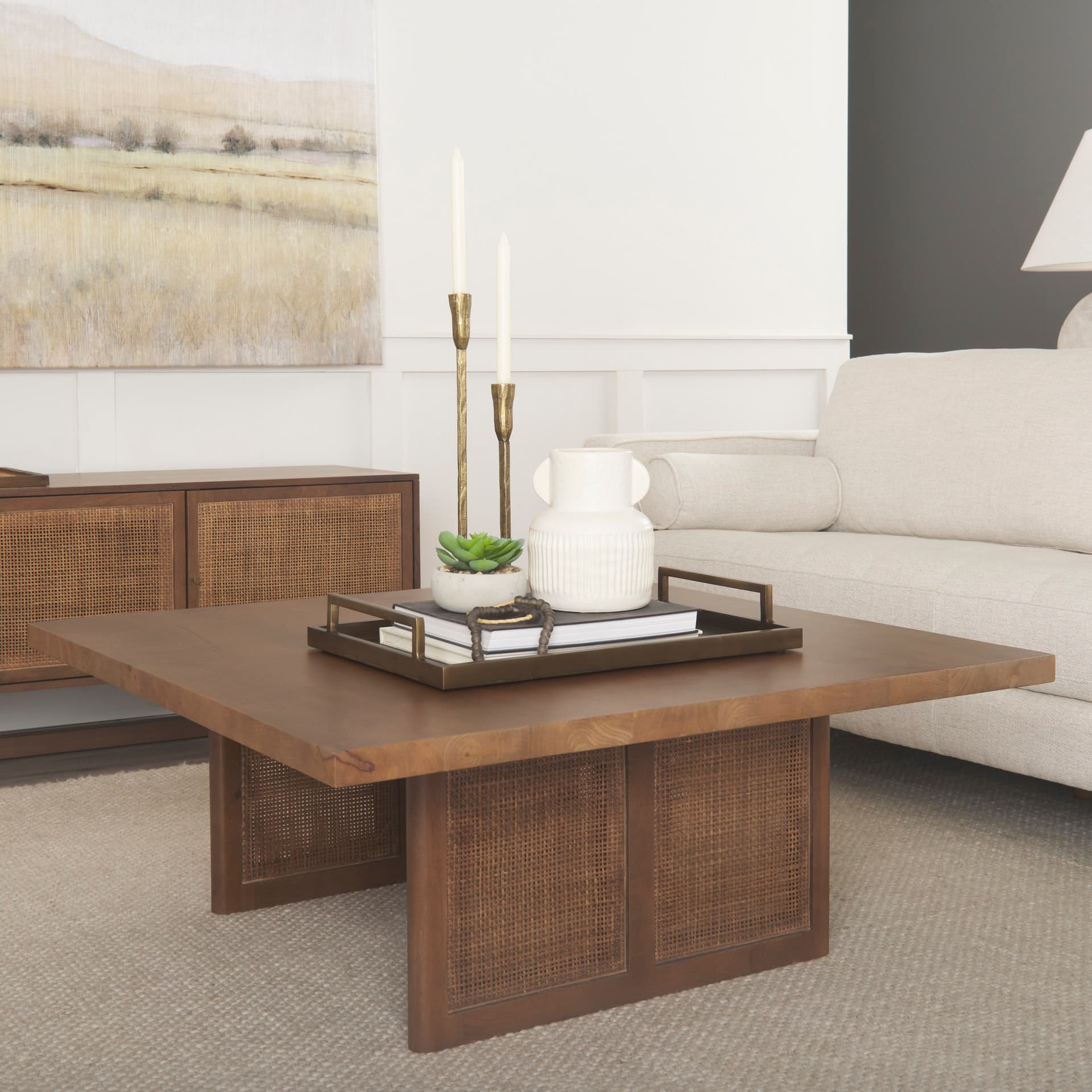 Grier 42" Square Medium Brown Solid Wood w/ Cane Coffee Table — in a styled room